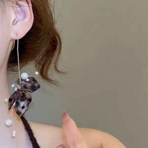 Detailed view of vintage acrylic petal earrings with gold chains and white pearls