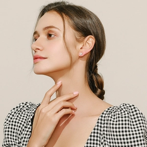 Elegant rectangular S925 sterling silver opal stud earrings worn by a fashion model