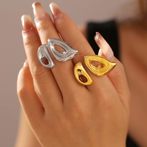 Minimalist 18k gold and silver geometric hollow rings worn in a stacked style