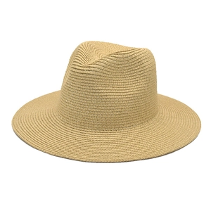 Detailed view of the fine weaving texture and teardrop crown of the beige straw sun hat