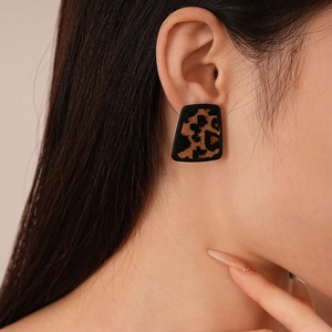 Retro faux leather leopard print trapezoid stud earrings for women on a model