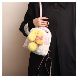 Close-up of fluffy pastel gradient plush backpack with yellow bunny ears and pink bow
