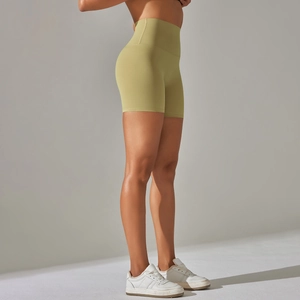 Detail view of high-waist seamless compression yoga shorts in olive green matte fabric