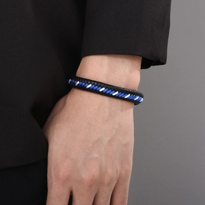 Close-up of braided leather cord bracelet with magnetic clasp in black blue and white