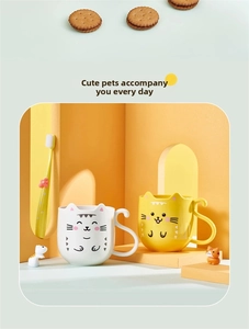 Detail of cute cat-themed ceramic cups with tail handles and matching flower toothbrush