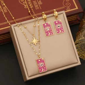 Star Moon Evil Eye necklace and earrings set in gold metal with pink enamel finish