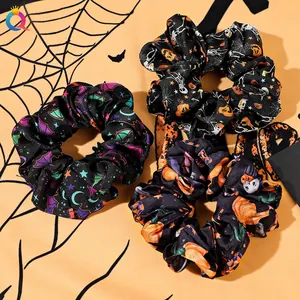 Three-piece Halloween scrunchie set with bat, pumpkin, and ghost prints on satin fabric