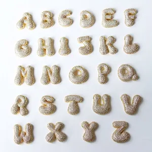 Macro display of full A-Z gold bubble letter pendants with sparkling crystal inlay