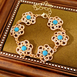 Detail of vintage gold flower bracelet with turquoise beads and sparkling rhinestones