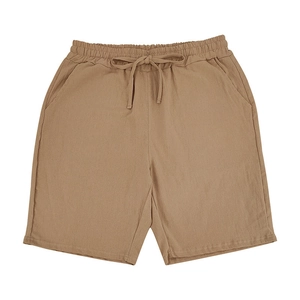 Detail of khakilinen shorts showing the elastic waistband, drawstring, and fabric texture