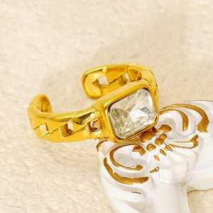 Macro shot of gold chain band ring featuring a rectangular zircon and adjustable opening
