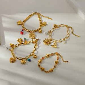 Detail of 18K gold plated stainless steel bracelets with flower and heart charms