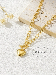 Detailed view of a gold heart pendant necklace with OT toggle clasp and 50.5cm length label
