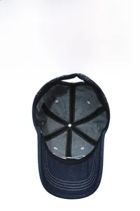 Internal view of navy denim baseball cap showing stitched seams and metal buckle strap