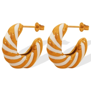 Twisted gold and white enamel C-shape hoop earrings in minimalist geometric design