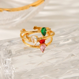 Macro view of gold-plated hammered ring featuring four colorful pear-cut zircon stones