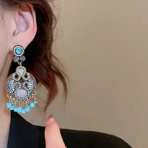 Bohemian leaf hollow tassel earrings with turquoise stones and vintage gold finish