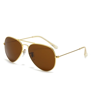 Classic aviator sunglasses with gold metal frame and dark brown lenses on white background