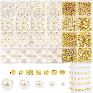 Detailed set of white pearls and golden alloy spacer beads in a clear organizer box