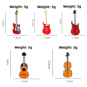 Detail view of colorful enamel musical instrument brooches showing guitars and violin