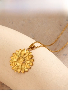 Detailed view of an 18K gold-plated sunflower pendant with intricate floral textures