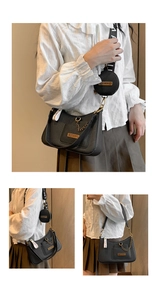 Detail of black crossbody bag featuring gold chain and detachable mini round coin purse