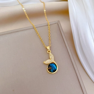 Elegant gold mermaid tail necklace with blue celestial stone and sparkling cubic zirconia