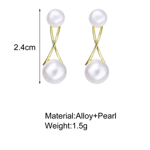 Detail view of twisted gold alloy drop earrings with large and small faux pearls