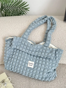 Light blue seersucker tote bag with a textured bubble finish and spacious shoulder design