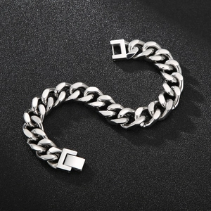Macro view of men's polished silver Cuban chain bracelet with secure square buckle clasp