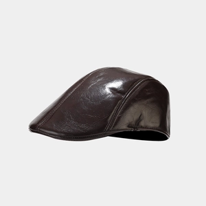 Close-up of a dark brown PU leather flat cap with glossy texture and detailed stitching