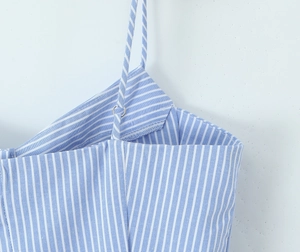 Close-up of adjustable straps and blue striped fabric on women's French camisole top