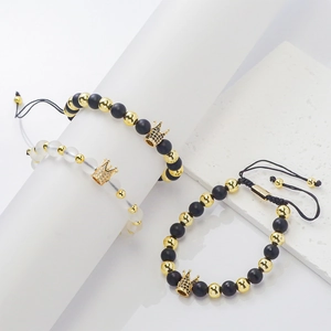 Detailed shot of three adjustable braided bracelets with gold crowns and natural stones