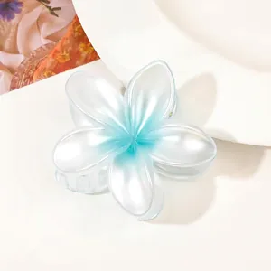 Detailed view of plumeria flower hair claw clip with blue and white gradient finish