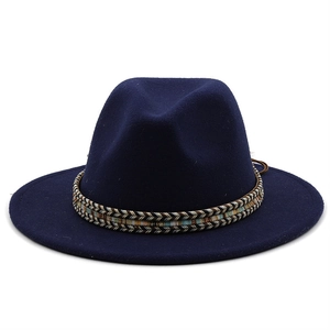 Detailed view of dark blue wool fedora hat featuring an ethnic style woven band decoration