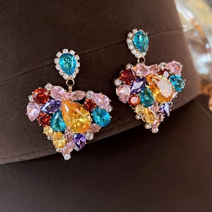 Macro shot of colorful pear-shaped cubic zirconia stones in a heart earring design