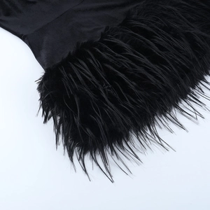 Detail shot of the black feather hem and smooth fabric on this strapless evening dress