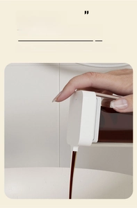 Detailed close-up of a smooth oil dispenser nozzle pouring liquid without dripping