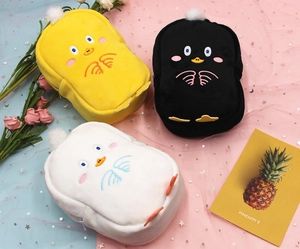 Close-up of cute plush duck storage bags with embroidery and soft pom-pom details