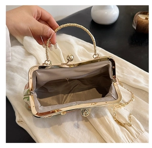 Detail view of the elegant floral embroidery evening bag with a secure interior zipper pocket