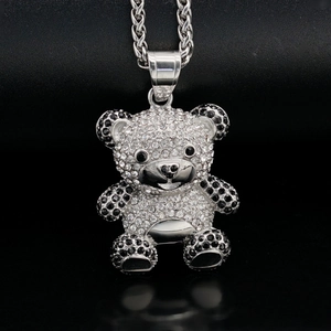 Macro shot of silver teddy bear pendant with sparkling rhinestones on twisted chain