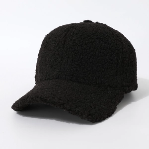 Close-up of warm black sherpa baseball cap showing soft fuzzy texture and thick material