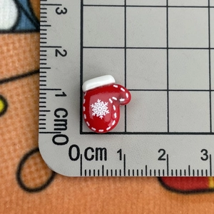 Mini red Christmas glove resin charm with white snowflake pattern and size measurement