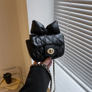 Chic black quilted mini crossbody bag with a large bow detail and gold chain strap