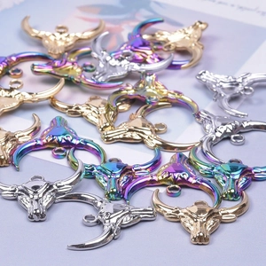 Macro detail of bull head charms in gold silver and rainbow finishes for jewelry making