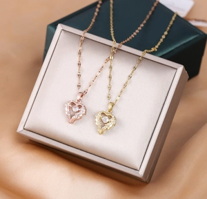 Close-up of heart pendants in rose gold and gold finish with sparkling zircon stones