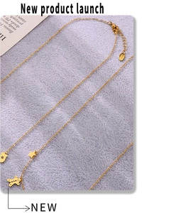 Detail of gold enamel Christmas necklace with gingerbread man and star charms on fur
