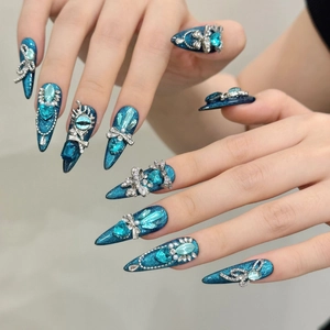 Deep blue long stiletto press-on nails with 3D crystal bows and luxury gemstone accents