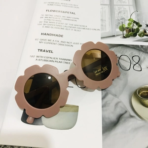Detail of flower-shaped kids sunglasses in soft pink with UV400 protection lenses