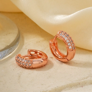 Elegant rose gold hoop earrings with micro-paved zircons on soft silk fabric